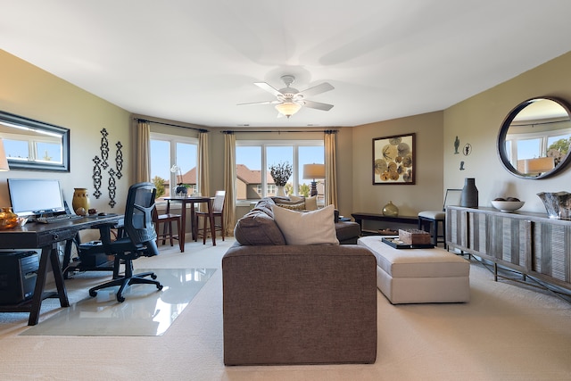 home office featuring ceiling fan and light carpet