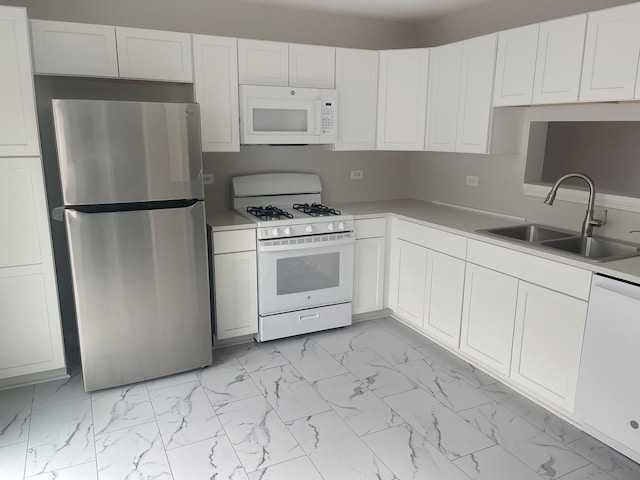 kitchen with white appliances, a sink, white cabinets, marble finish floor, and light countertops