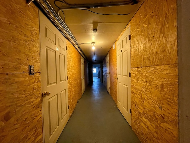 hallway with wood walls