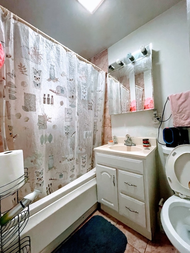 full bathroom featuring toilet, shower / tub combo, vanity, and tile patterned flooring