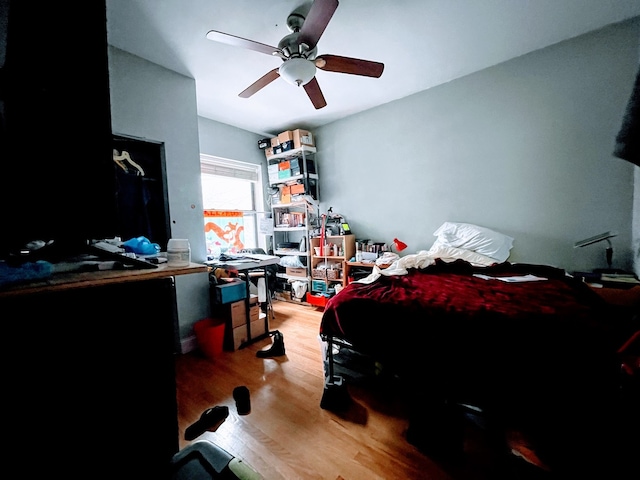 bedroom featuring hardwood / wood-style floors and ceiling fan