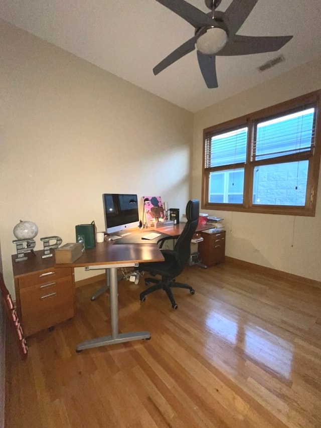 office with light hardwood / wood-style flooring and ceiling fan