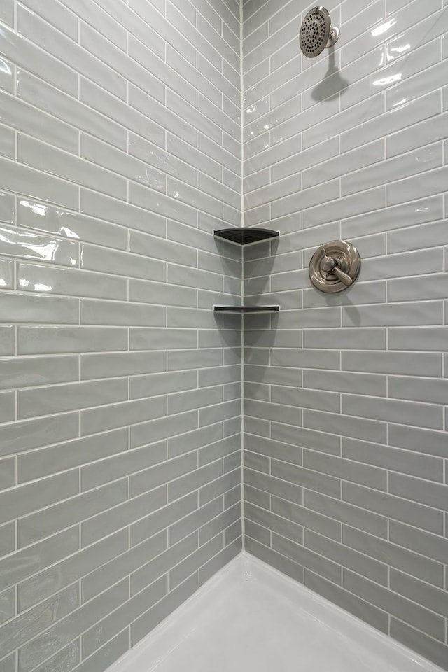 bathroom with a tile shower