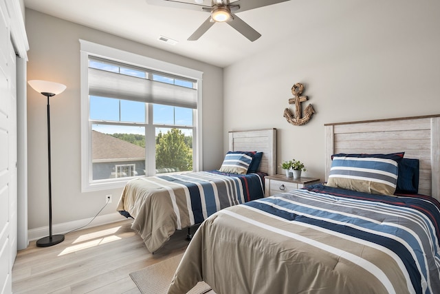 bedroom with ceiling fan and light hardwood / wood-style floors