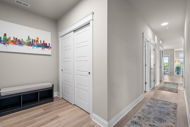 corridor featuring light hardwood / wood-style floors