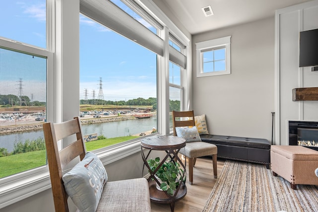 sunroom with plenty of natural light and a water view