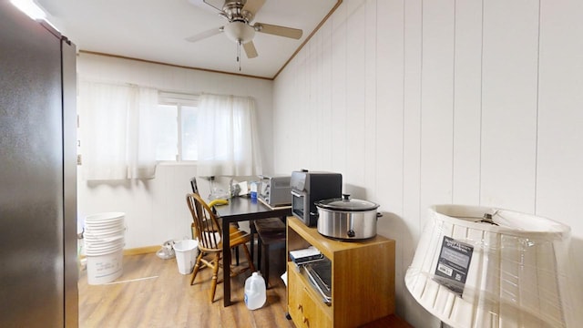 home office featuring crown molding, light hardwood / wood-style flooring, and ceiling fan