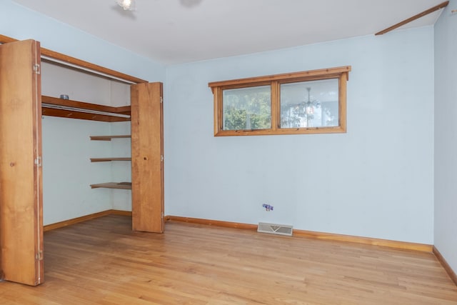 unfurnished bedroom featuring a closet and light hardwood / wood-style floors