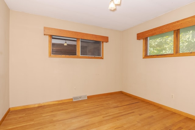 spare room with hardwood / wood-style floors