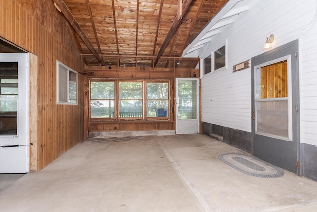 unfurnished sunroom featuring lofted ceiling