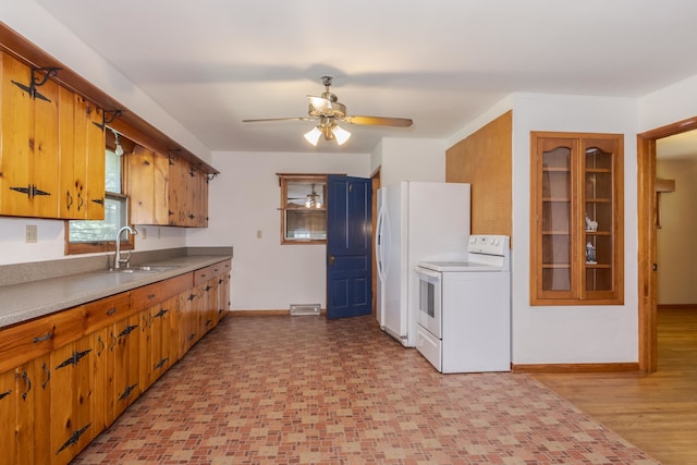 kitchen with light hardwood / wood-style flooring, white appliances, ceiling fan, and sink