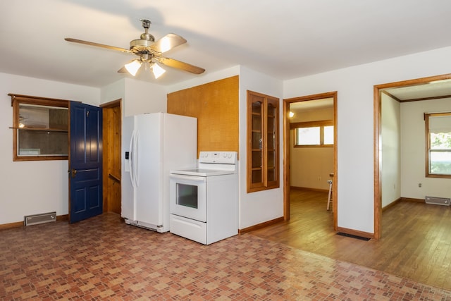 kitchen featuring white appliances, light hardwood / wood-style flooring, a baseboard heating unit, ceiling fan, and blue cabinets