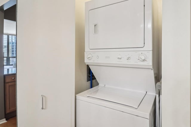 clothes washing area with laundry area and stacked washer / dryer