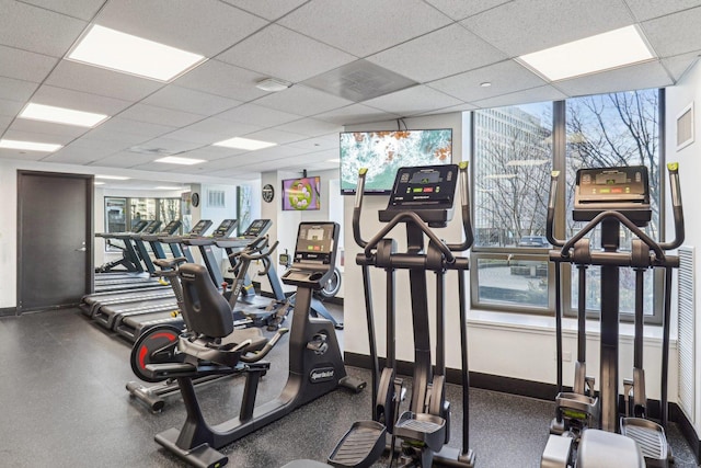 workout area with baseboards and a drop ceiling