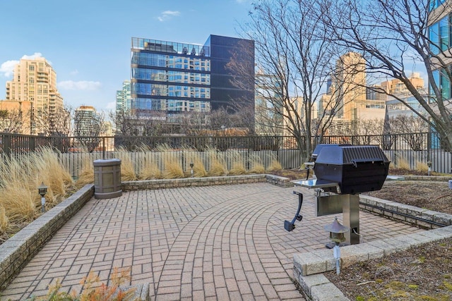 view of community featuring a city view, a patio, and fence