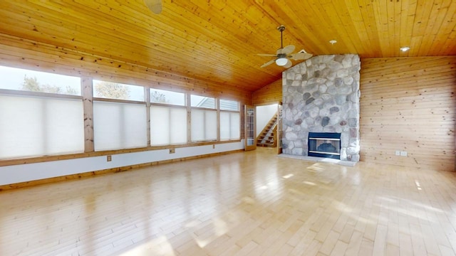 unfurnished living room featuring hardwood / wood-style floors, vaulted ceiling, wood ceiling, and ceiling fan