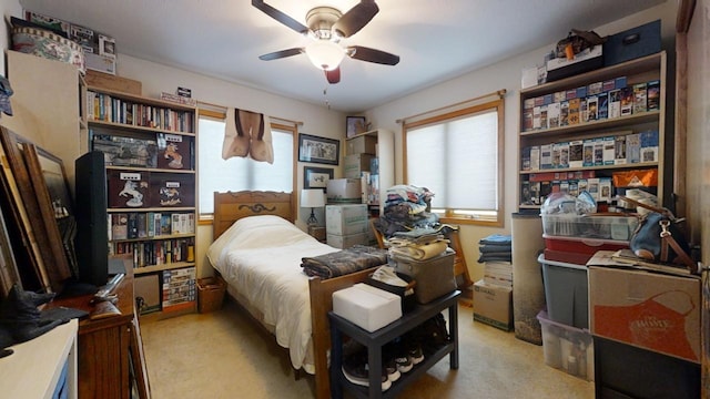 bedroom with light carpet and ceiling fan