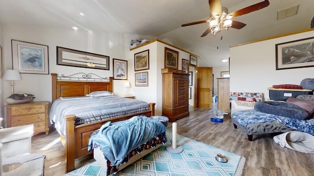 bedroom with ceiling fan, wood-type flooring, and vaulted ceiling