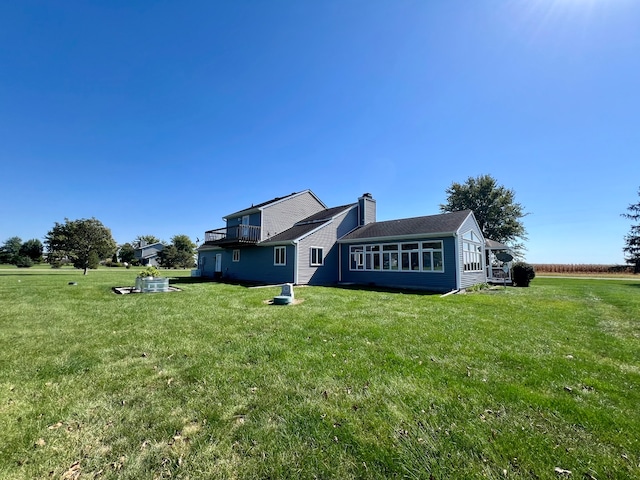 back of property featuring a yard