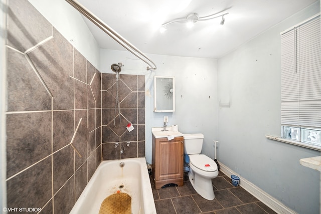 full bathroom featuring tiled shower / bath, toilet, tile patterned floors, and vanity