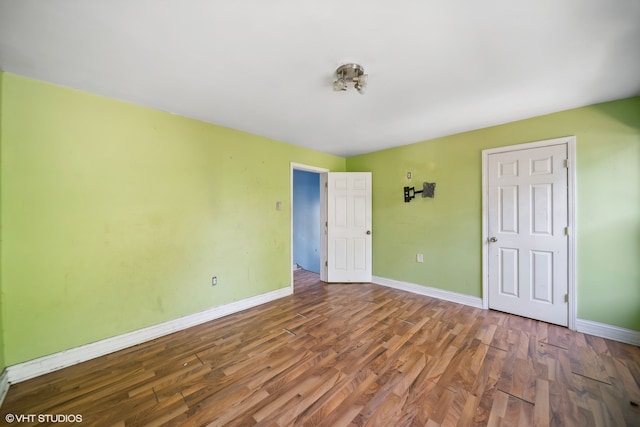 unfurnished room featuring hardwood / wood-style flooring