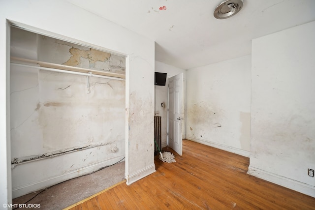 unfurnished bedroom featuring hardwood / wood-style flooring