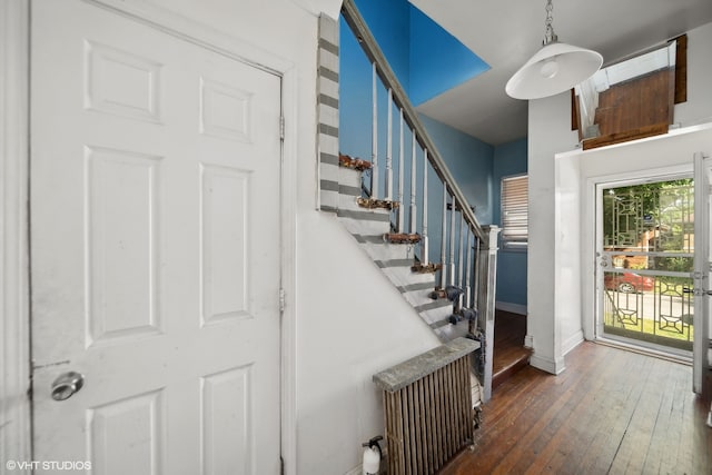 stairway with radiator and wood-type flooring