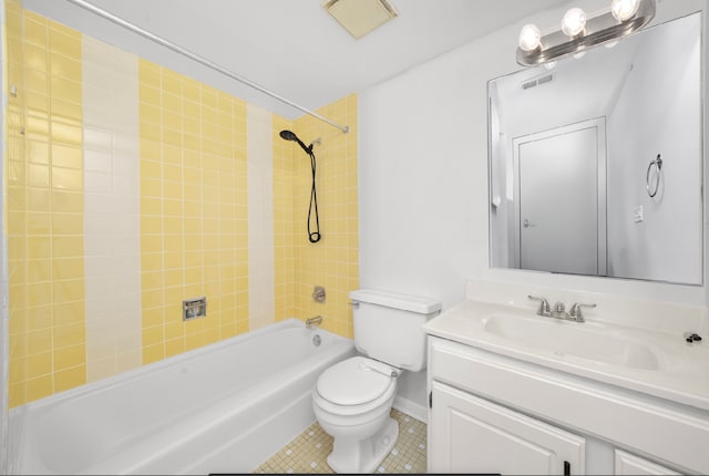 full bathroom featuring vanity, toilet, tile patterned floors, and tiled shower / bath combo