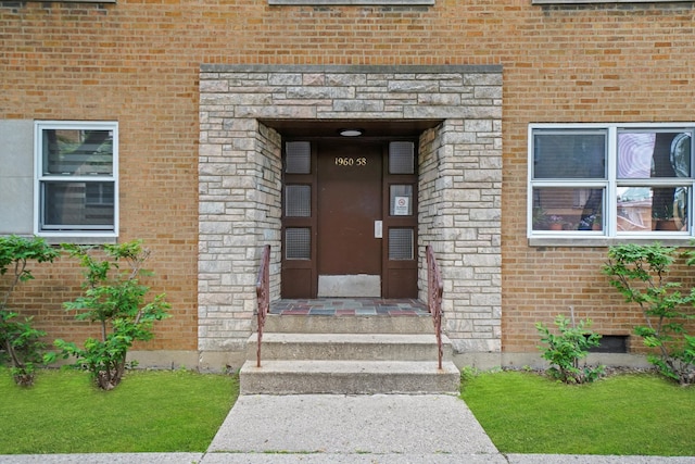 property entrance with a lawn