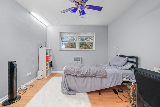 bedroom with ceiling fan and light hardwood / wood-style floors