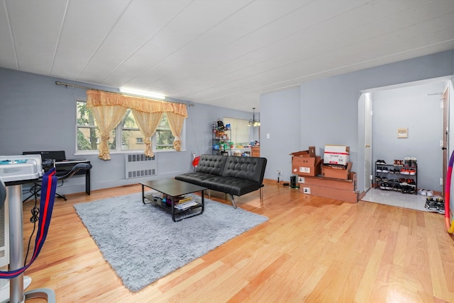 living room featuring radiator heating unit and light hardwood / wood-style floors