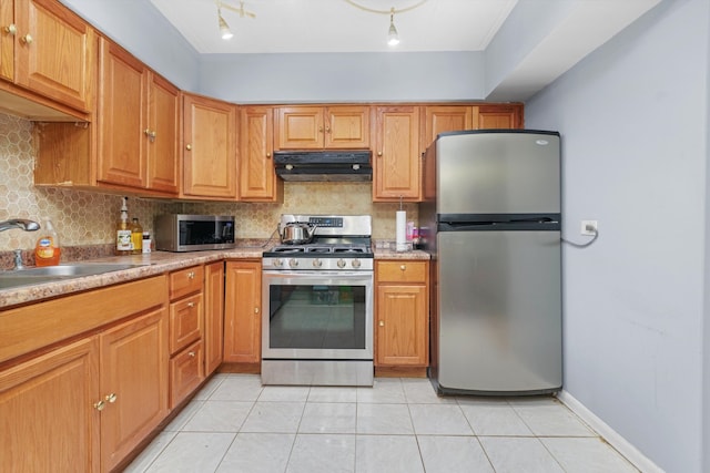 kitchen with tasteful backsplash, ventilation hood, light tile patterned floors, sink, and stainless steel appliances