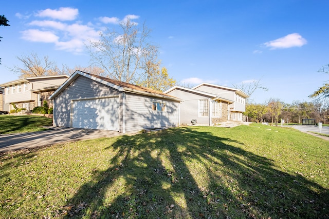 view of side of property featuring a yard and a garage