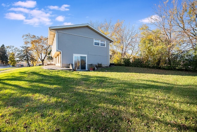 view of side of home featuring a lawn