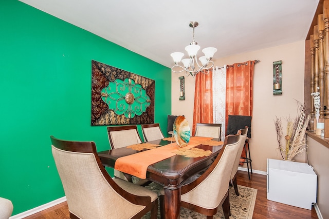 dining area featuring a chandelier and dark wood-type flooring