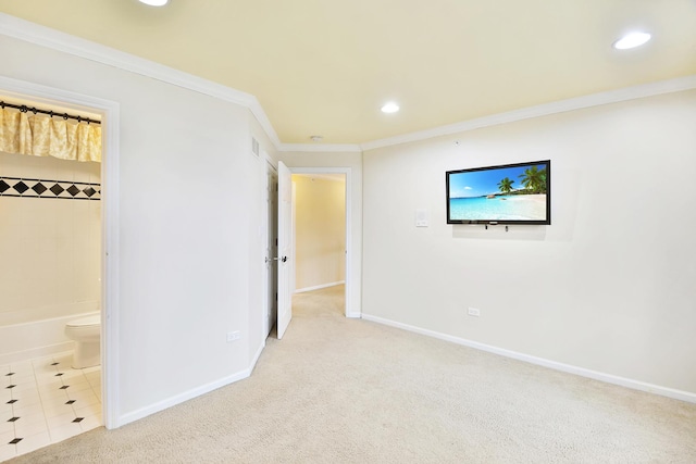 unfurnished bedroom with connected bathroom, ornamental molding, and light colored carpet