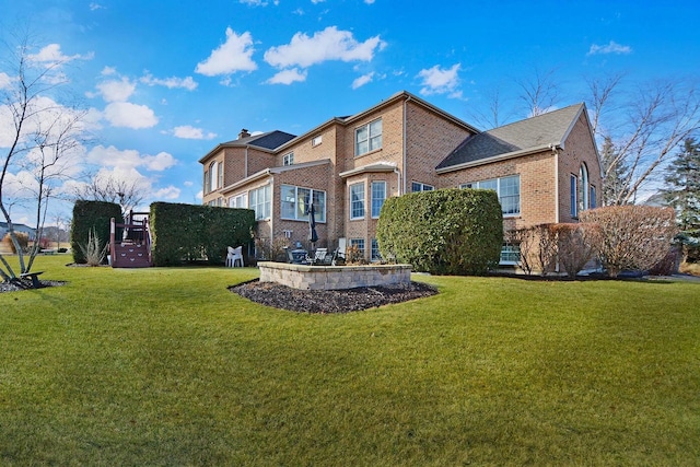 rear view of property with a lawn