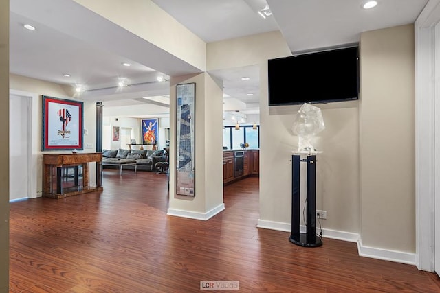 interior space featuring dark wood finished floors, recessed lighting, and baseboards