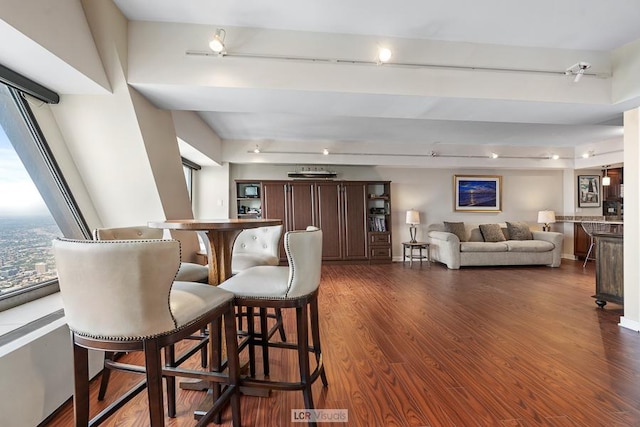 bar with dark wood finished floors, baseboards, and indoor bar