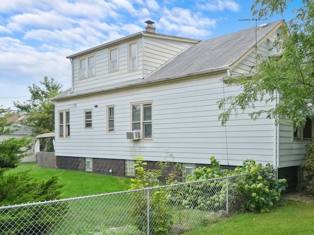 view of home's exterior with a yard and cooling unit