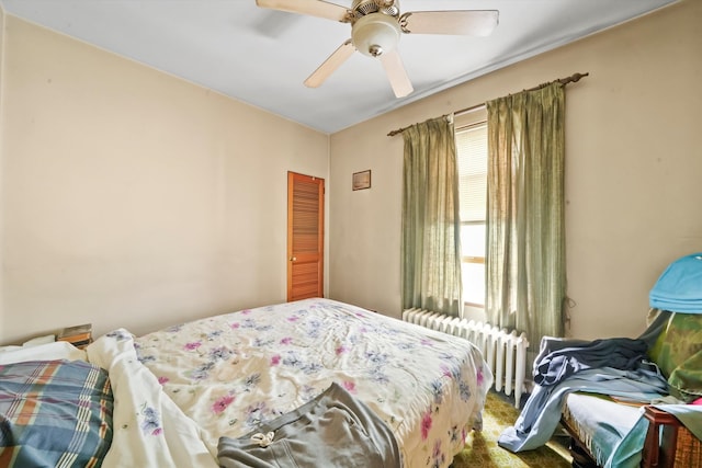 bedroom with carpet, ceiling fan, and radiator