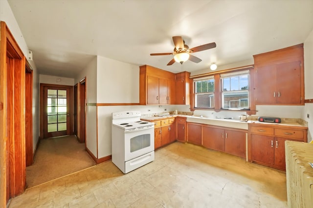 kitchen with radiator, white range with electric stovetop, sink, and ceiling fan