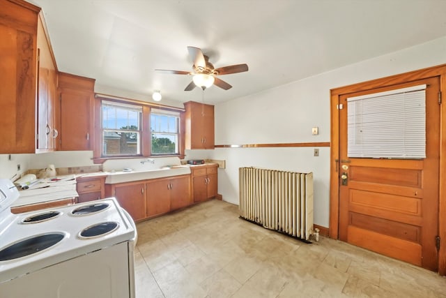 kitchen featuring ceiling fan, radiator, and white range with electric cooktop