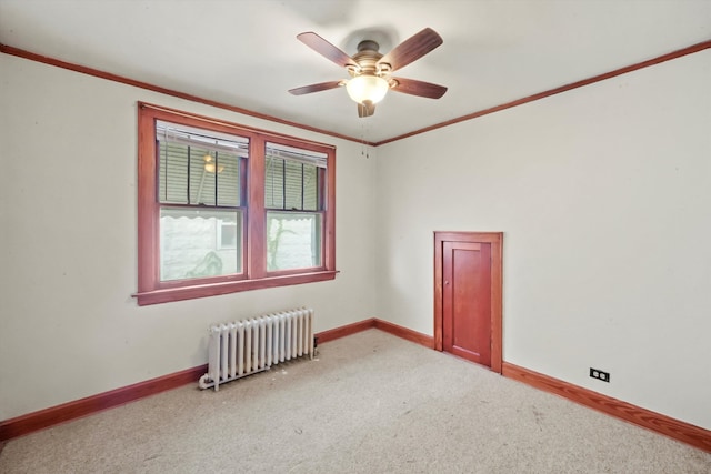 unfurnished room featuring radiator heating unit, crown molding, ceiling fan, and carpet floors