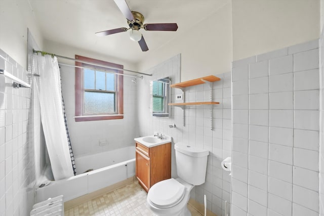 full bathroom with shower / bath combo, toilet, tile walls, ceiling fan, and vanity