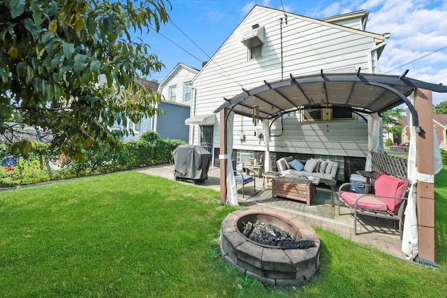 view of yard with an outdoor living space with a fire pit and a patio