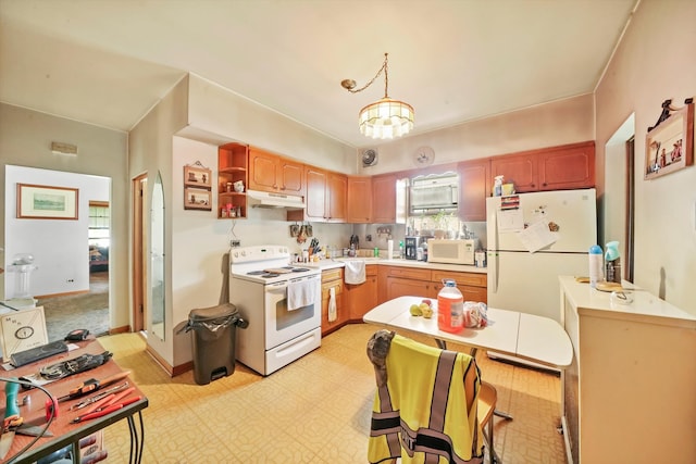 kitchen featuring pendant lighting, white appliances, and a notable chandelier