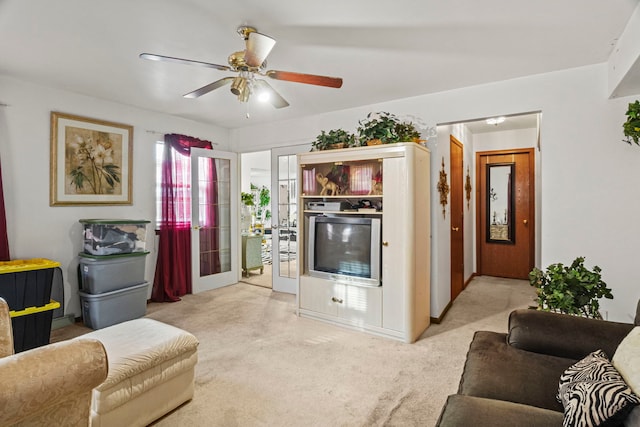 living room featuring ceiling fan and carpet floors