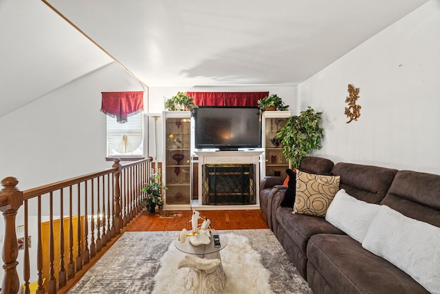 living area with wood finished floors and a fireplace