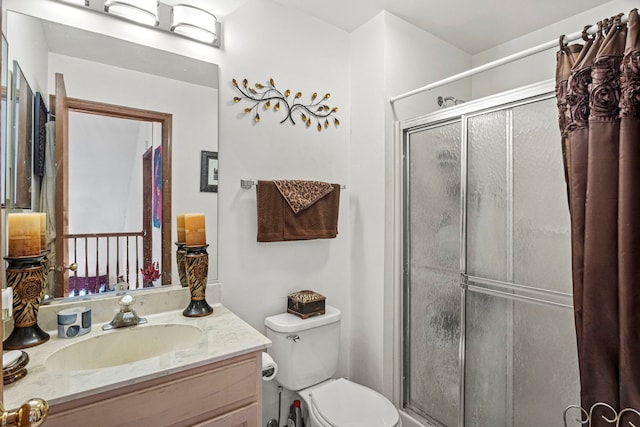 full bath featuring vanity, a shower stall, and toilet